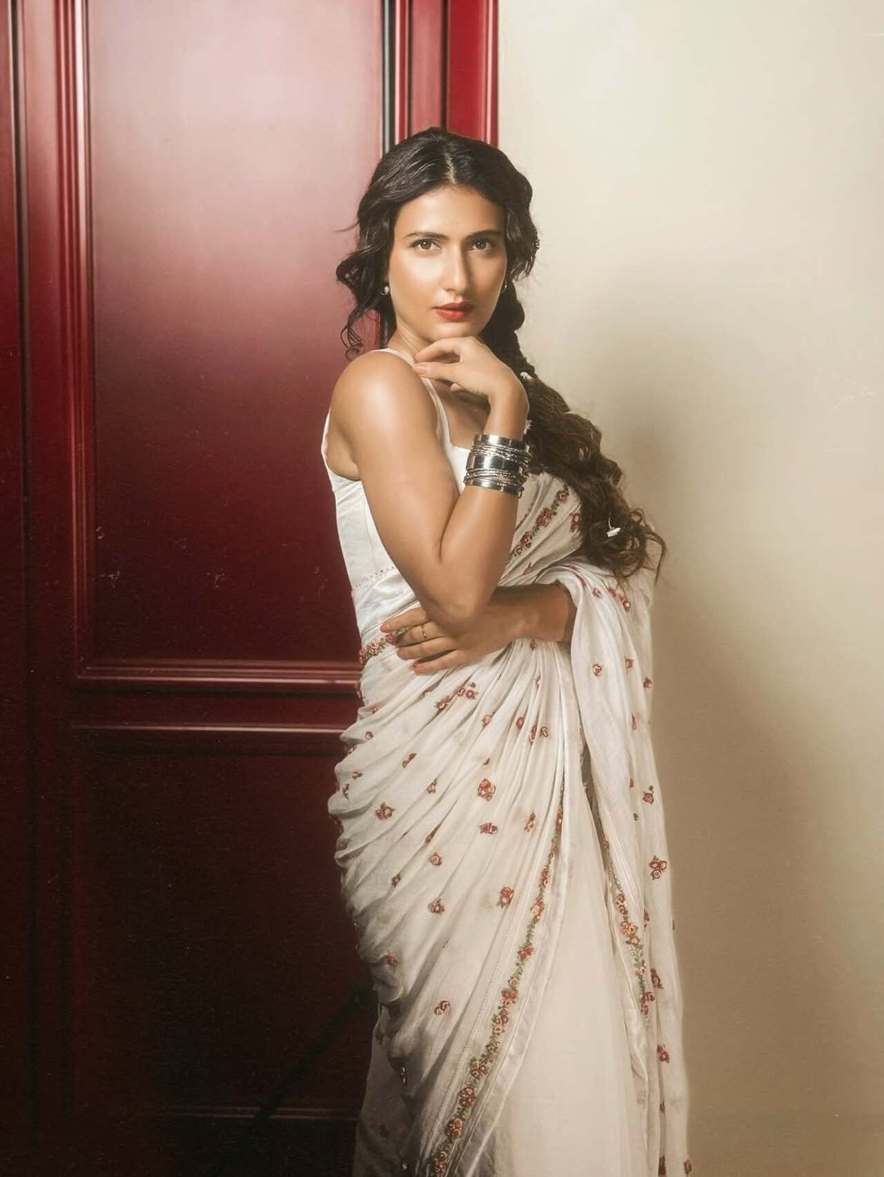 Fatima stuns in a delicate white saree adorned with floral motifs, accessorized with stacked silver bangles—timeless, simple, and graceful